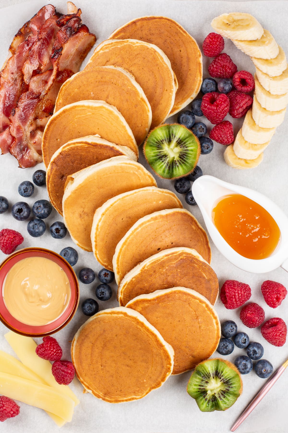 Charcuterie board with pancakes and fruit