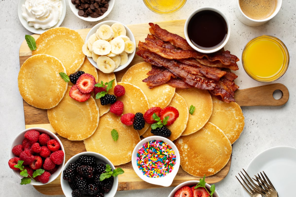 Breakfast charcuterie board with pancakes and bacon