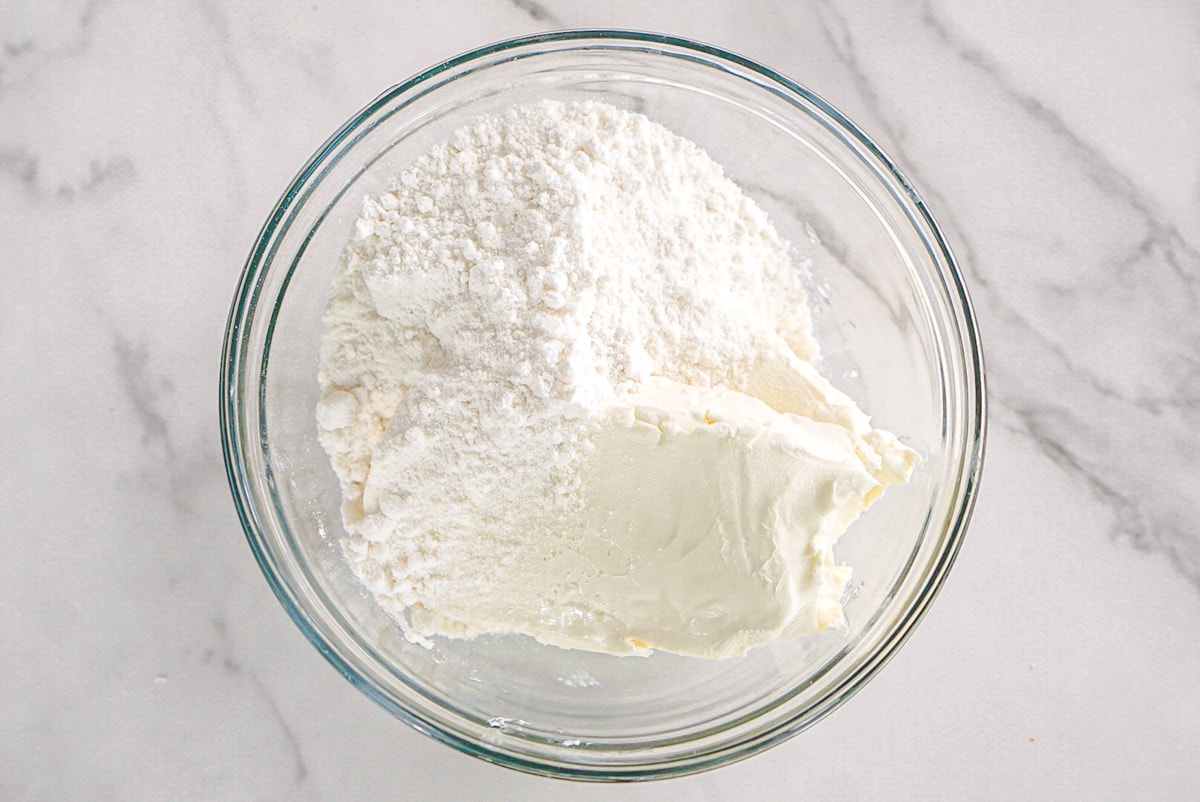 Cream cheese, sugar and cake mix in bowl