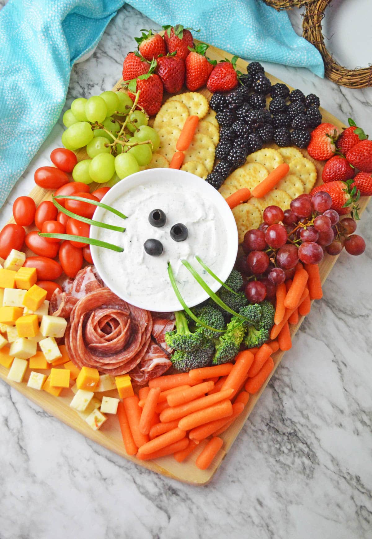 Charcuterie board with dip, fruits, veggies, cheese and crackers