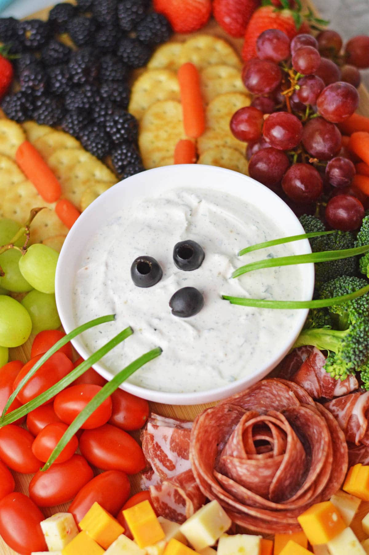 Veggie dip with olives and green onions to look like the Easter bunny