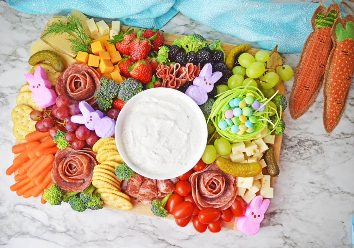 Easter themed charcuterie board with blue towel