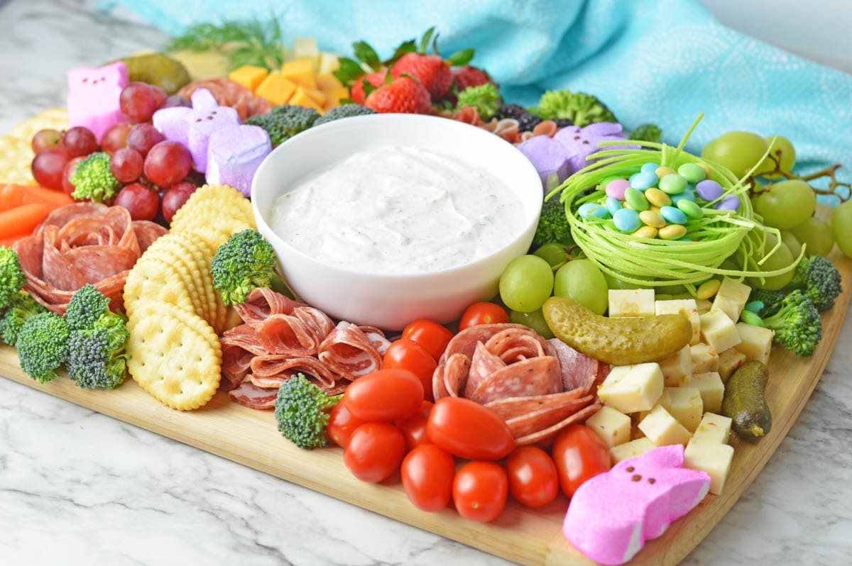 Beautiful Easter Charcuterie Board with meats, cheeses, fruits and candy