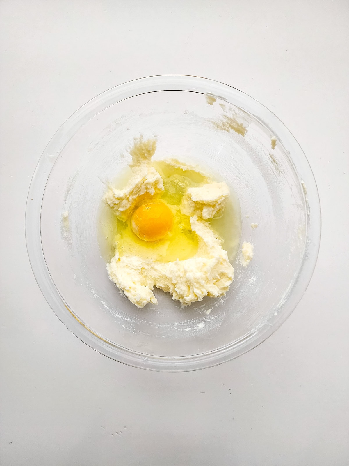 Egg and lemon juice with sugar mixture in glass bowl