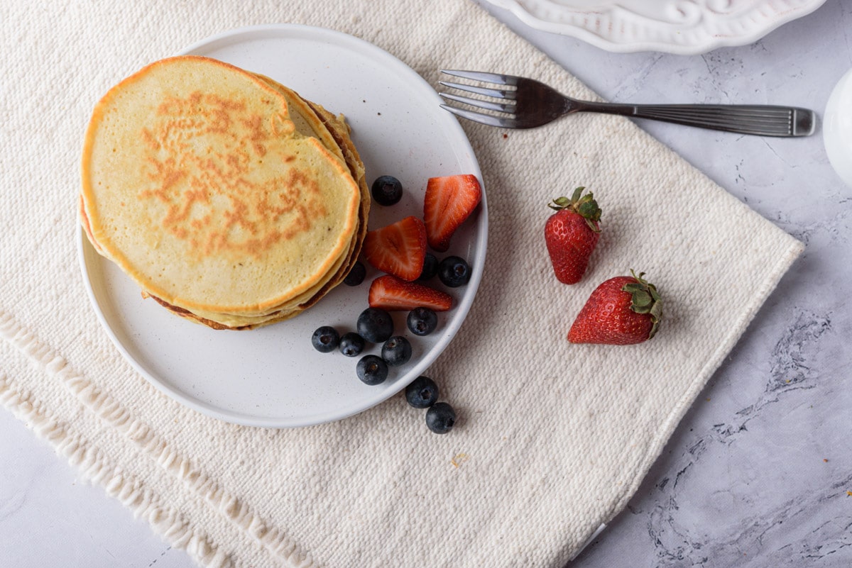 Pancakes on plate with fruit