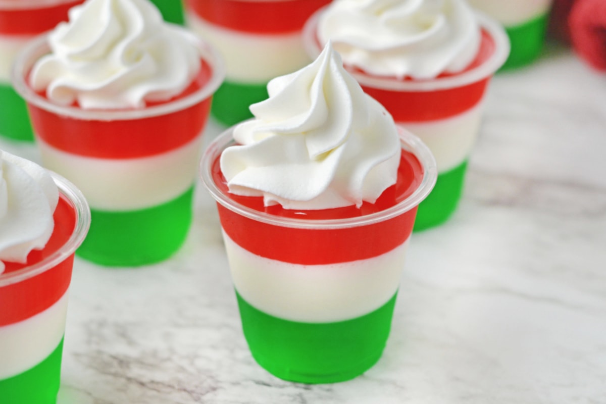 Red white and green jello shot on marble counter