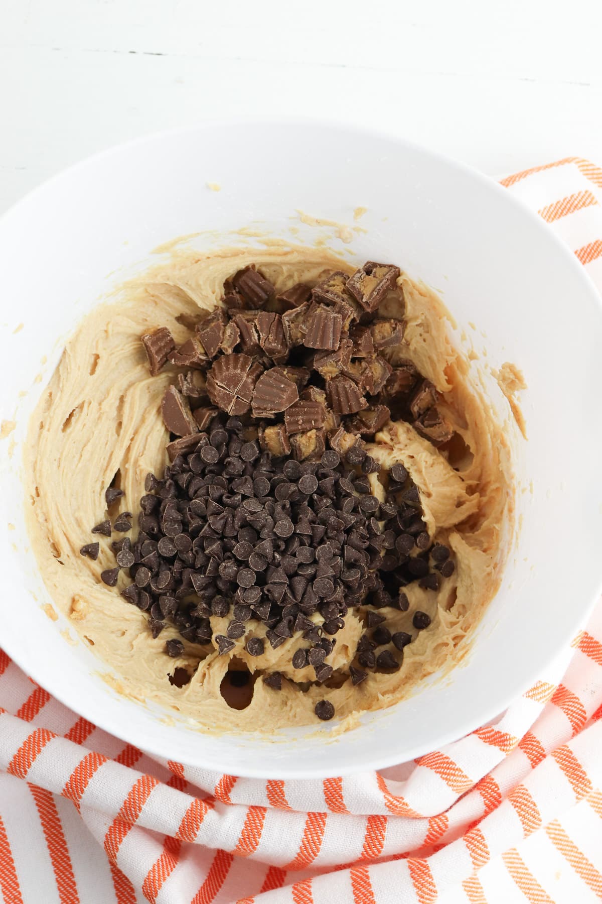 Peanut butter mixture combines with chocolate and Reese's in a bowl