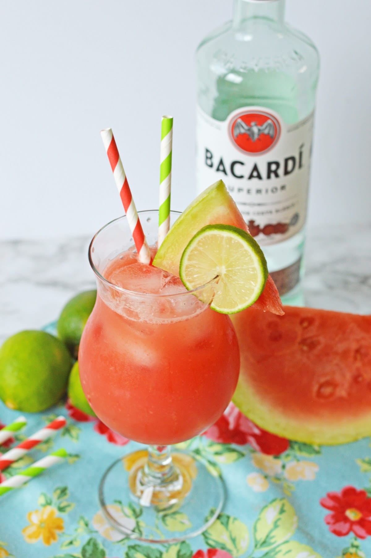 Watermelon rum punch garnished with lime and watermelon wedge