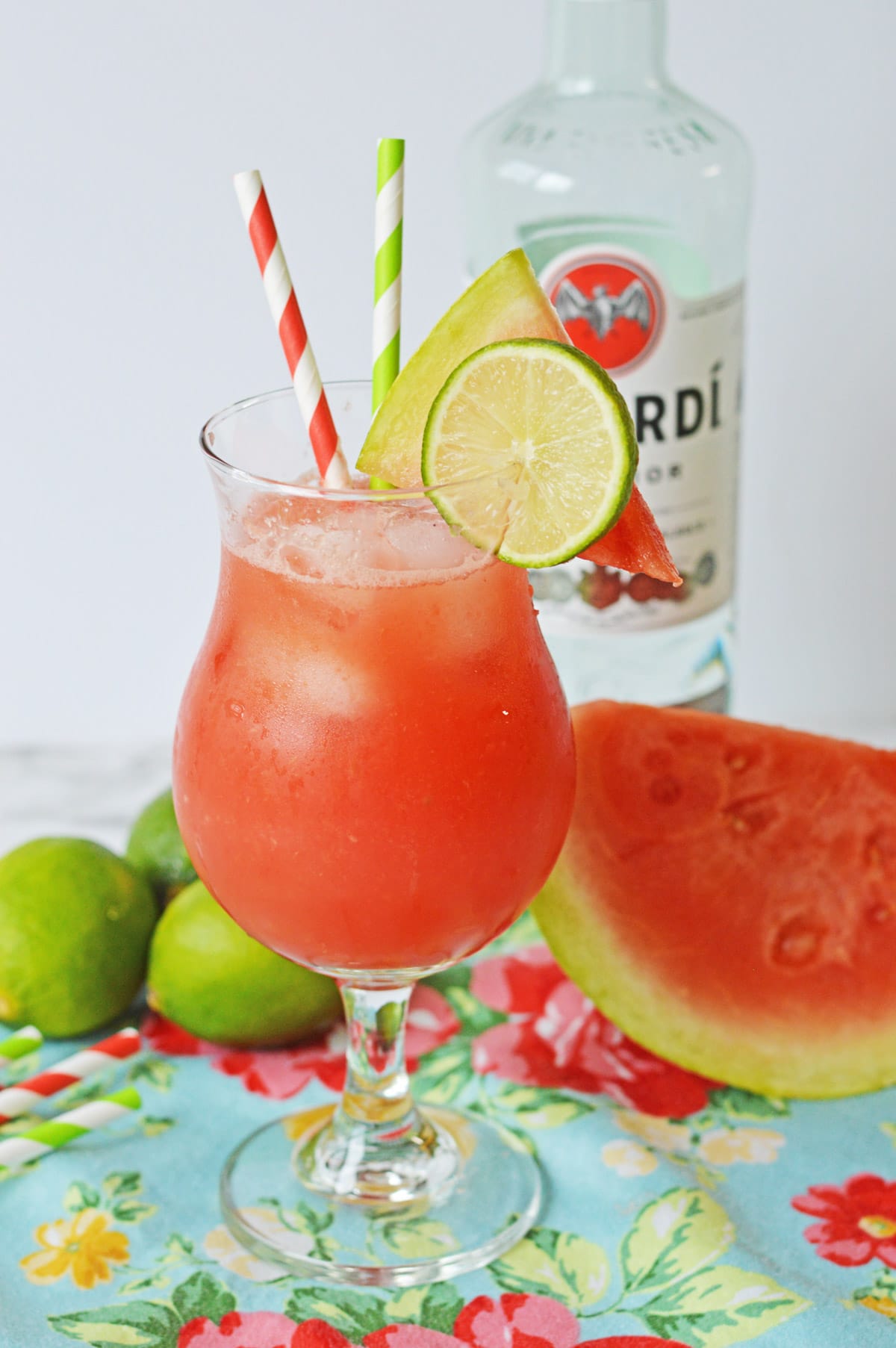 Watermelon rum punch in hurricane glass with colorful straws