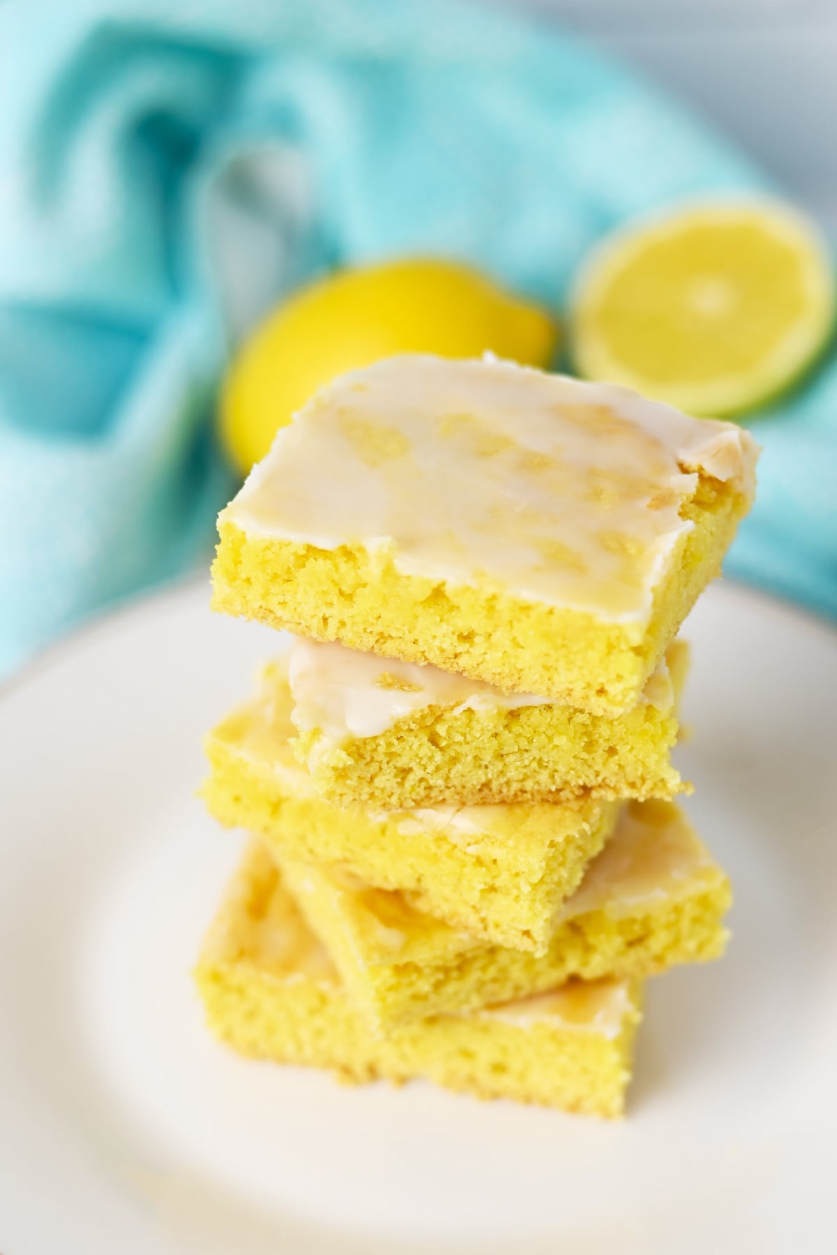 Lemon cake mix bars stacked on a plate