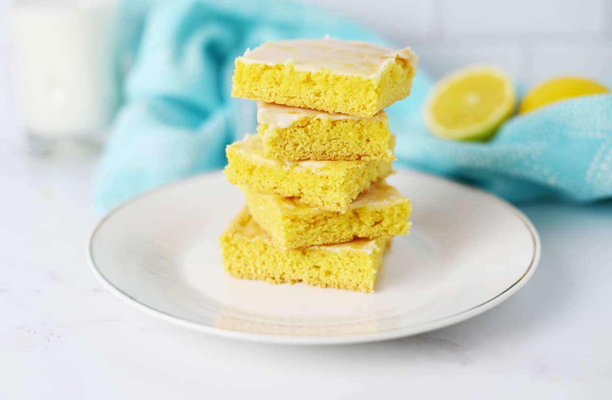 Lemon bars with cake mix stacked with blue towel behind