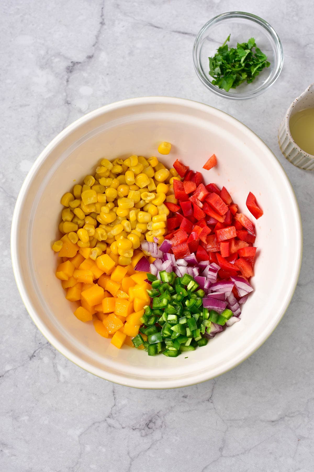 Ingredients for mango corn salsa in bowl