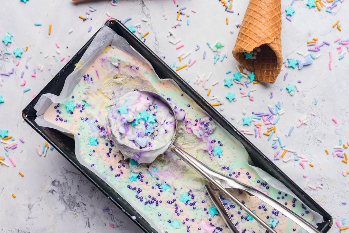 Colorful ice cream with ice cream scoop and cones