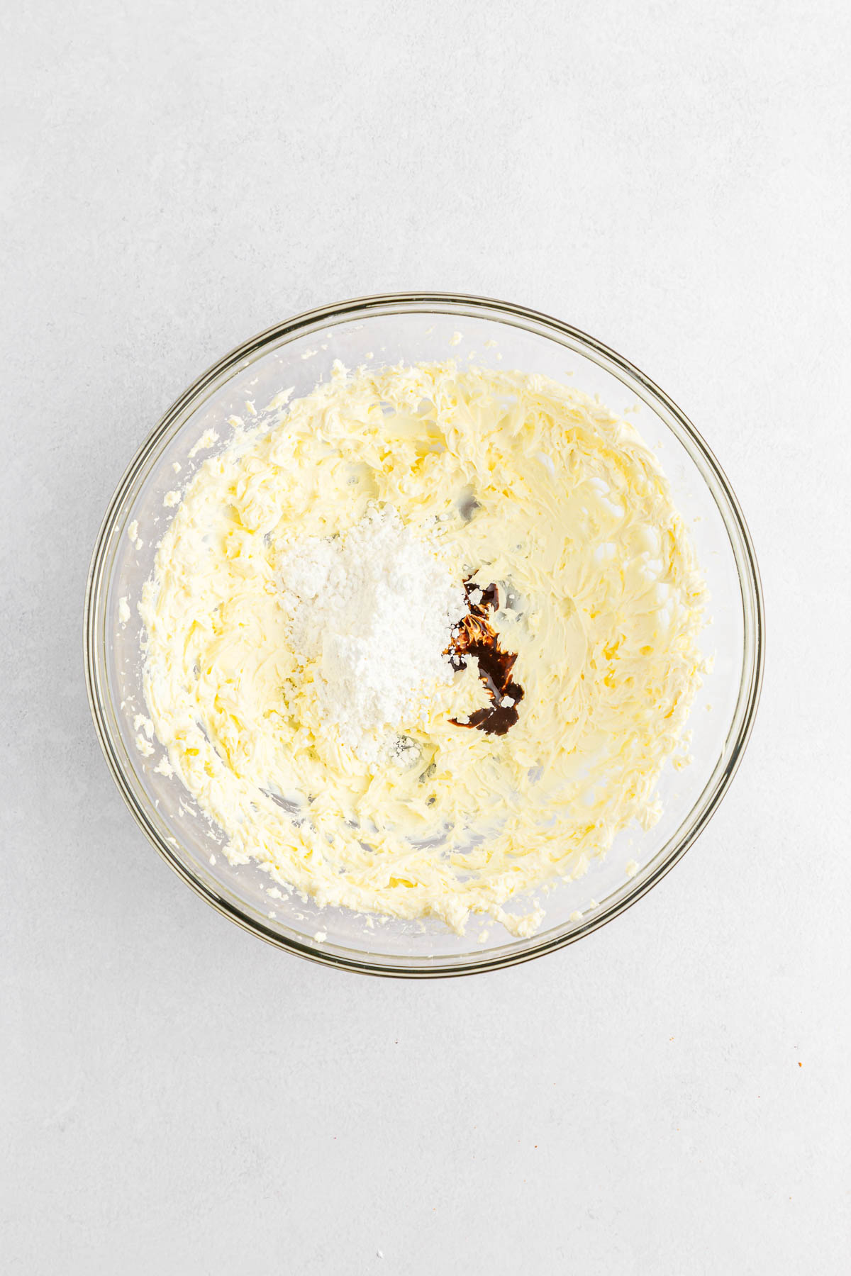 Cream cheese, sugar and vanilla extract in bowl