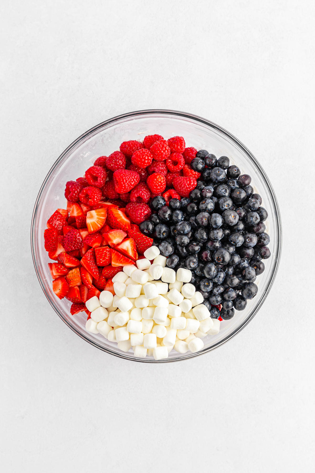 Fruit and marshmallows in glass bowl