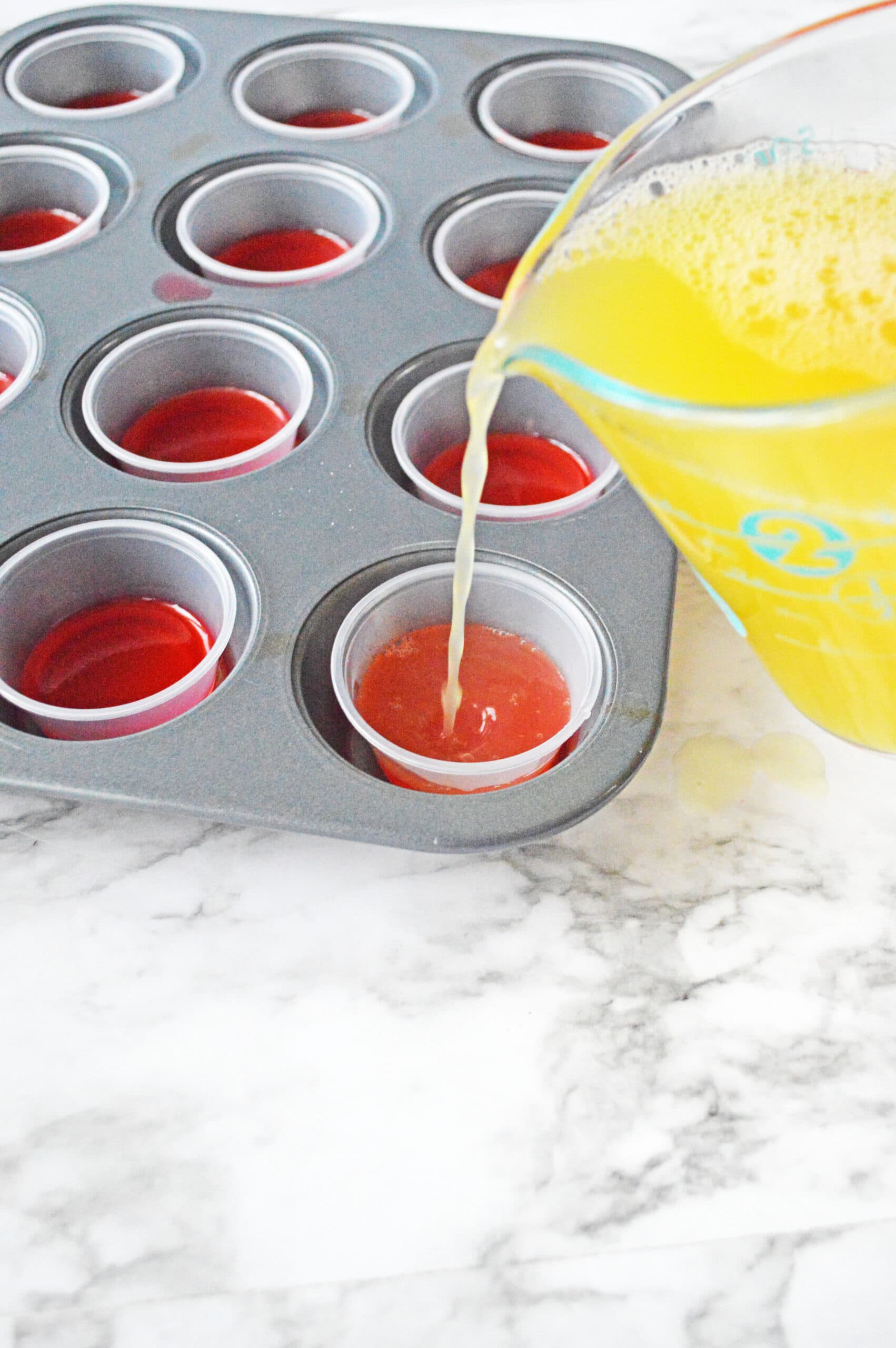 Pouring pineapple mixture into jello cups