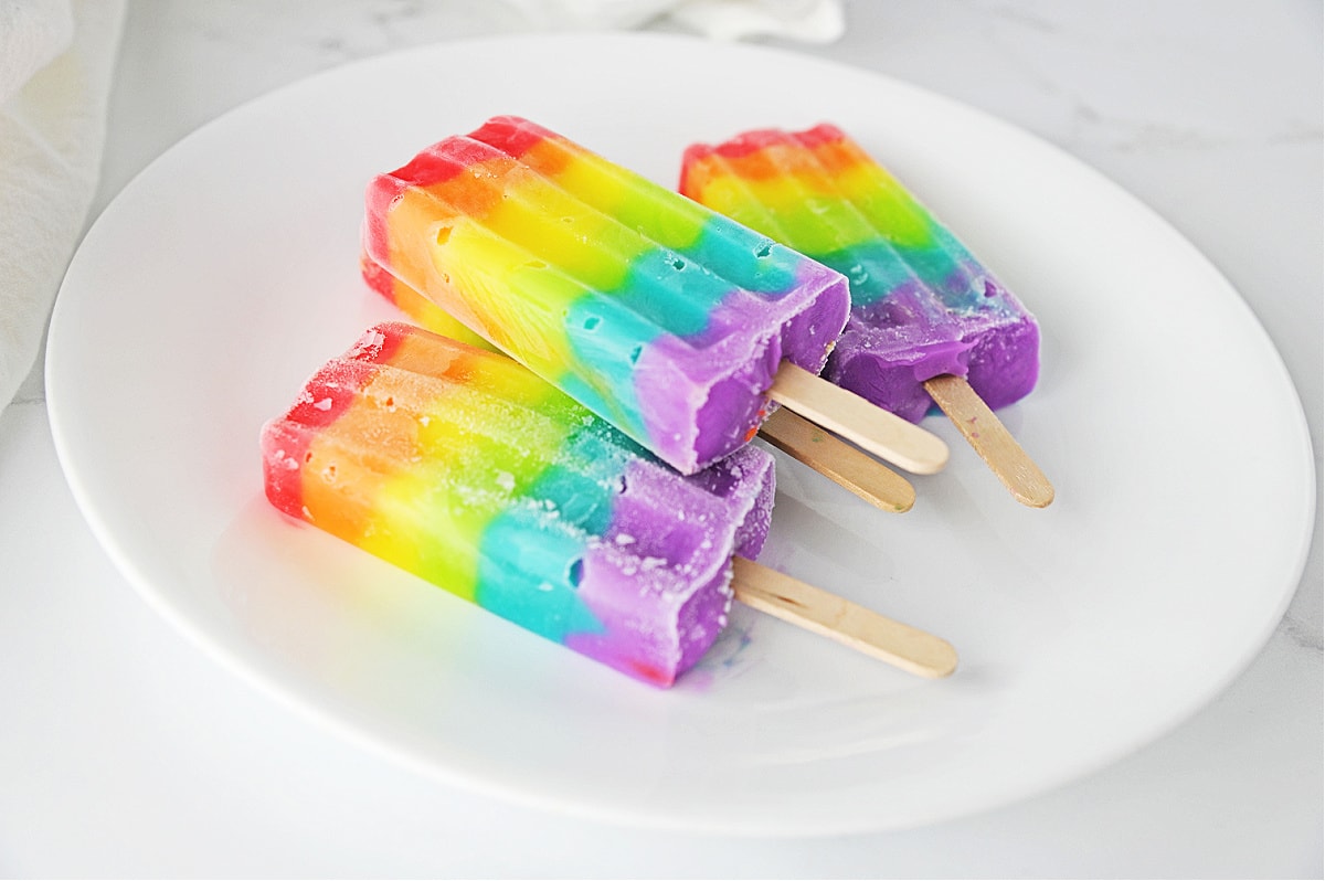 Rainbow popsicles on white plate