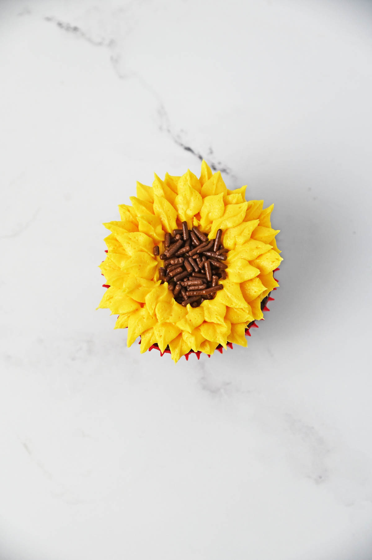 Sunflower cupcakes with brown sprinkles in center