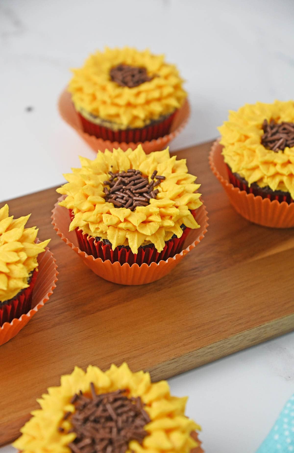 Sunflower cupcakes on wooden board