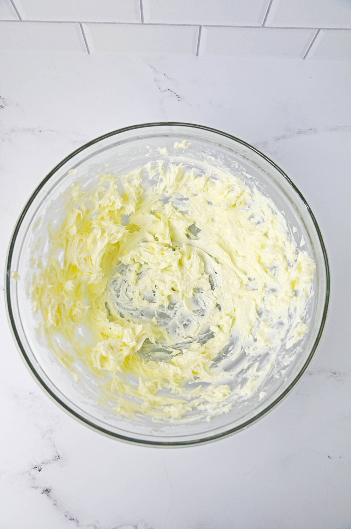 Softened butter in glass bowl