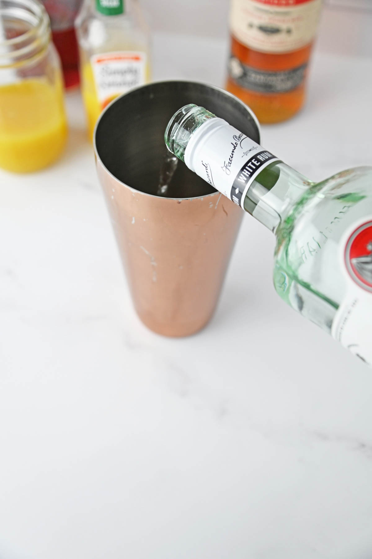 Adding rum to cocktail shaker