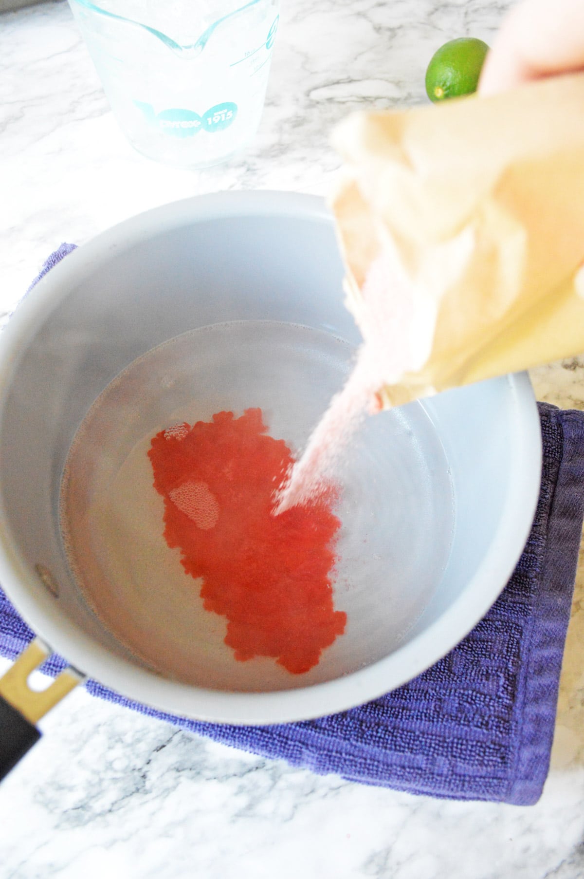 Pouring Jello mix into water