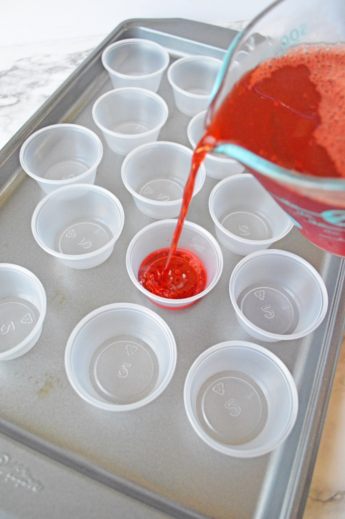 Pouring jello into jello cups