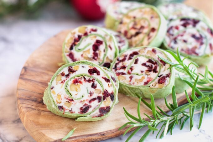 Fresh homemade cranberry pinwheels made with cream cheese, dried cranberries, walnuts, goats cheese and rosemary