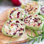 Fresh homemade cranberry pinwheels made with cream cheese, dried cranberries, walnuts, goats cheese and rosemary