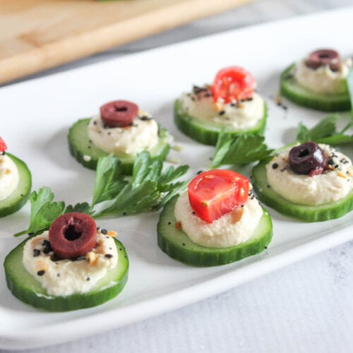 Cucumber hummus appetizer on white plate