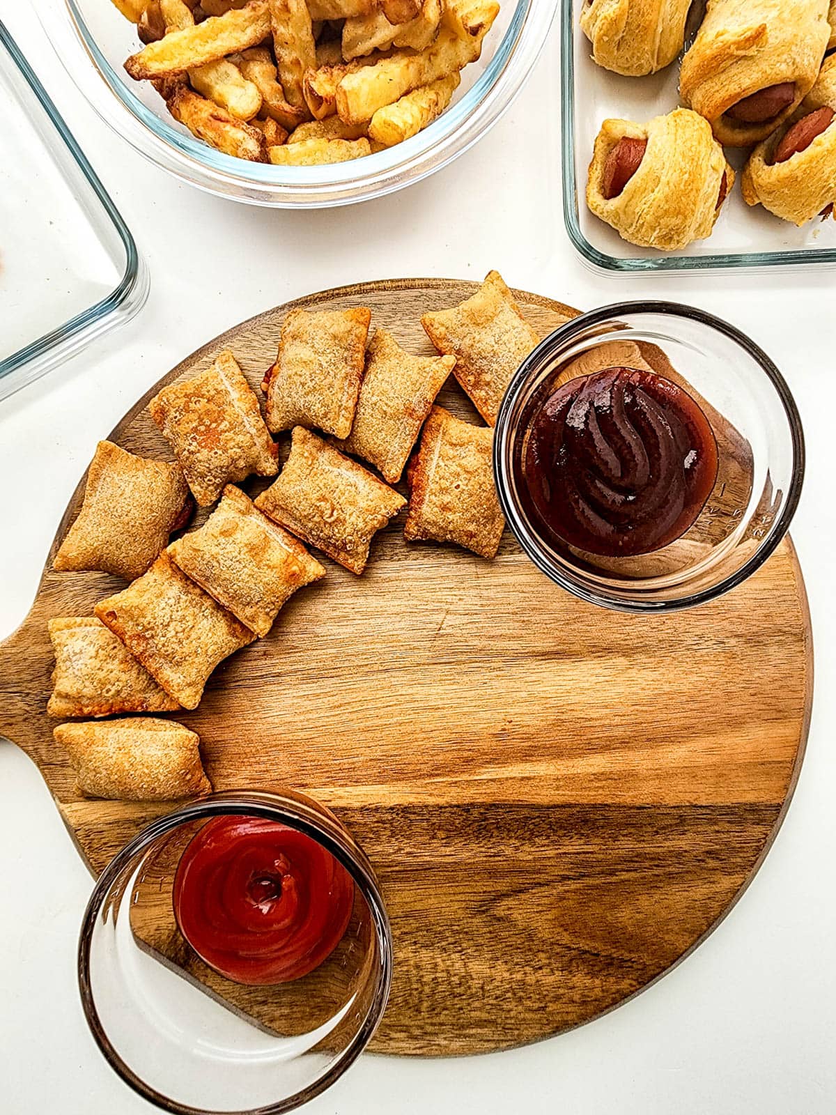 Pizza rolls with dipping sauces on wooden board