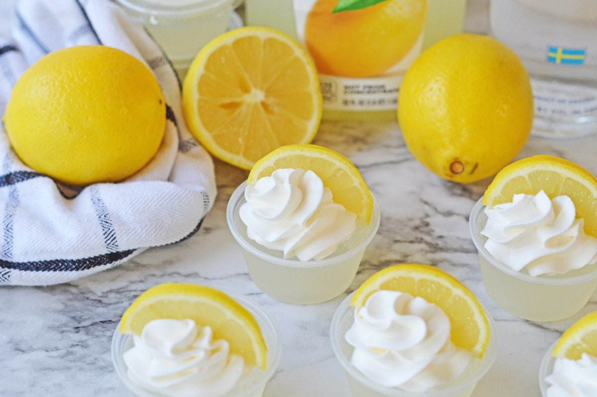 Lemonade jello shots with black and white towel and lemons