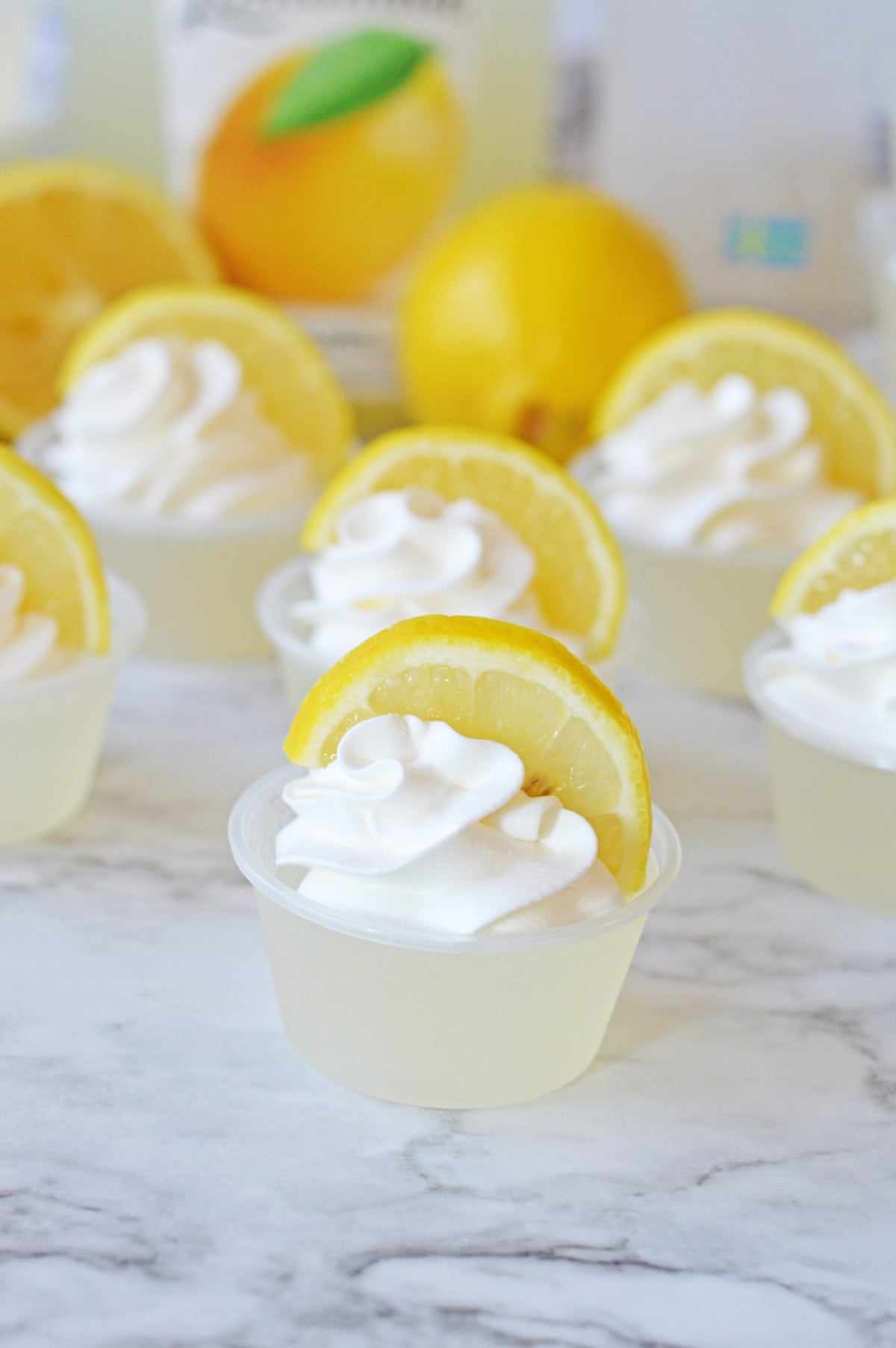 Lemonade jello shot with whipped cream and lemon slice
