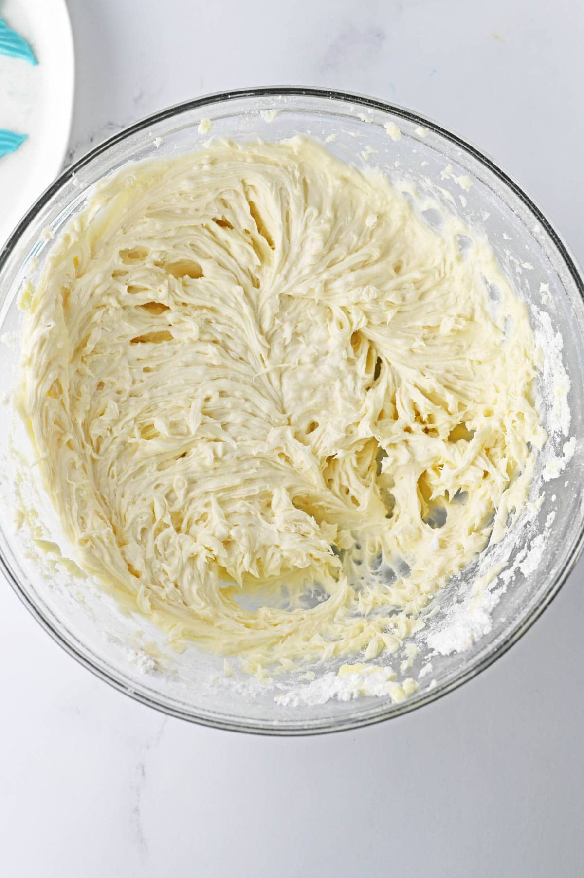 Buttercream frosting in glass bowl