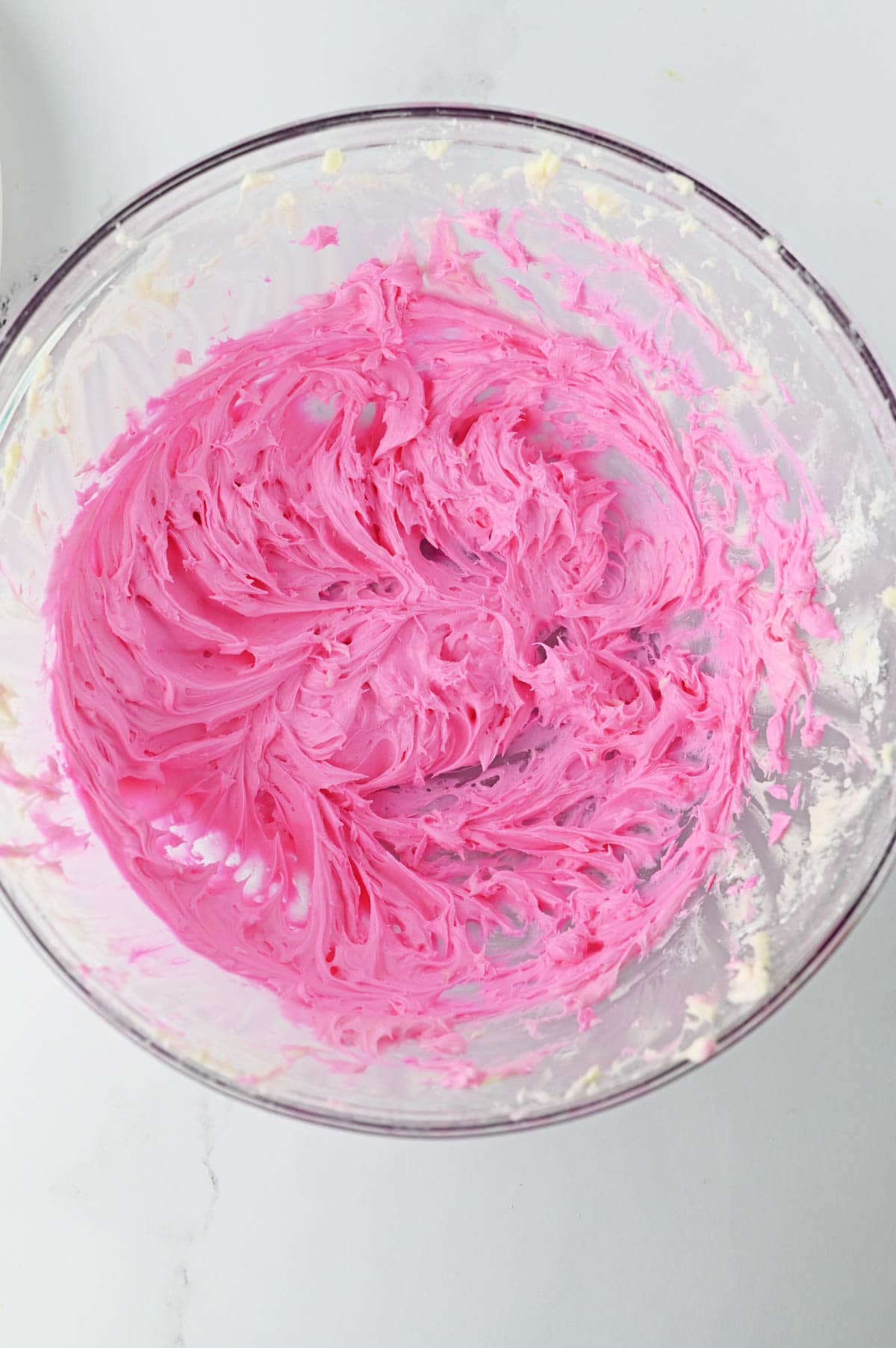 Buttercream frosting colored with pink food coloring