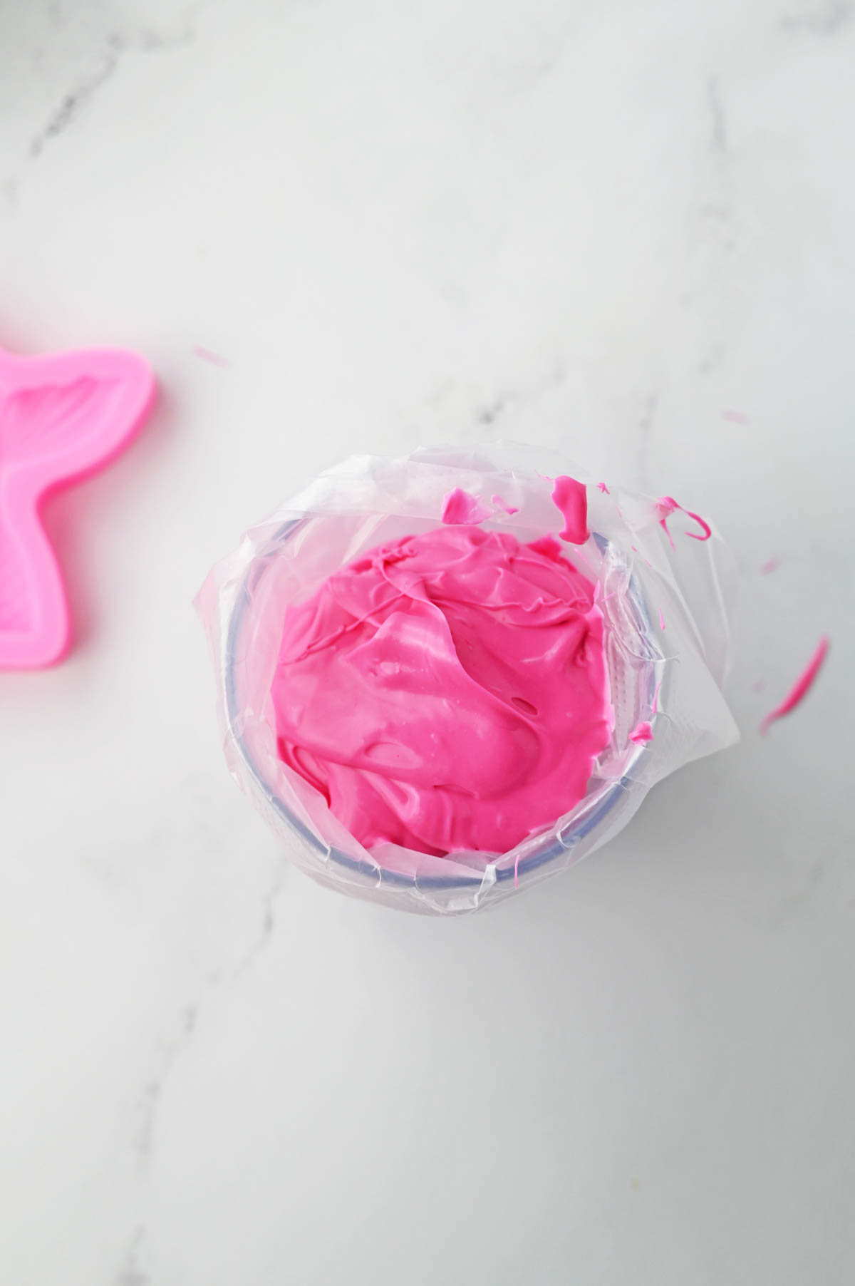 Melted pink candy in piping bag