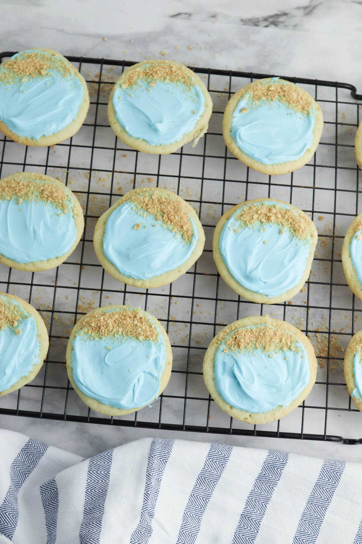 Sugar cookies with blue frosting and crushed graham crackers