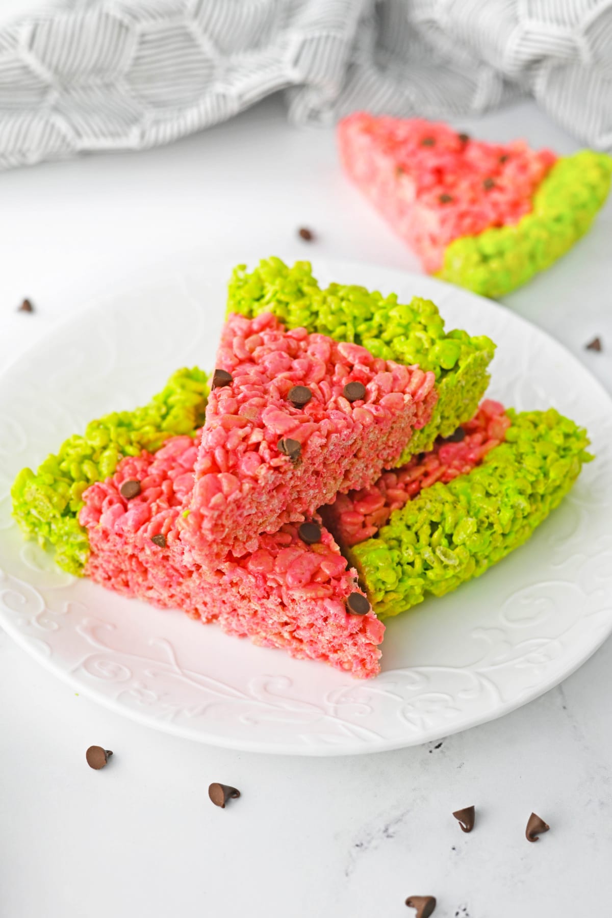 Watermelon rice krispie treat slices on white plate