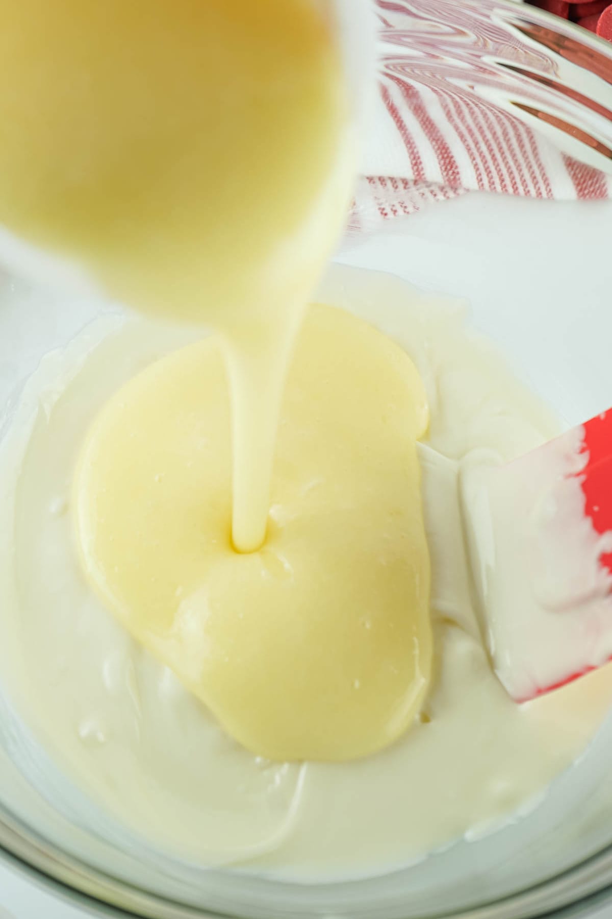Pouring melted icing into melted white chocolate