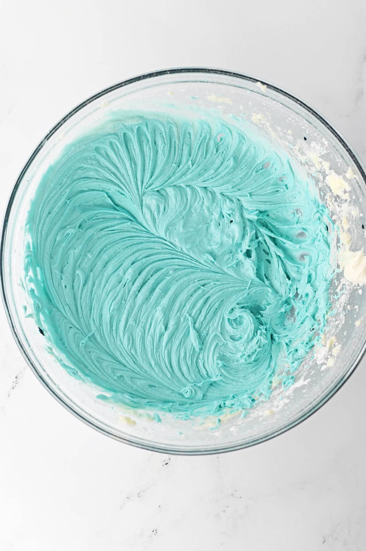 Blue icing in glass bowl