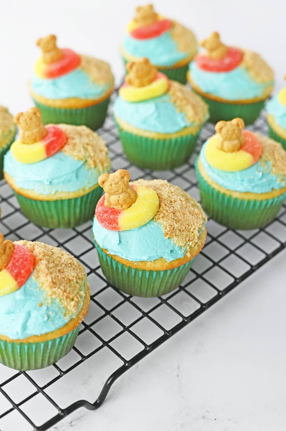 Teddy grahams in ring candies on top of cupcakes