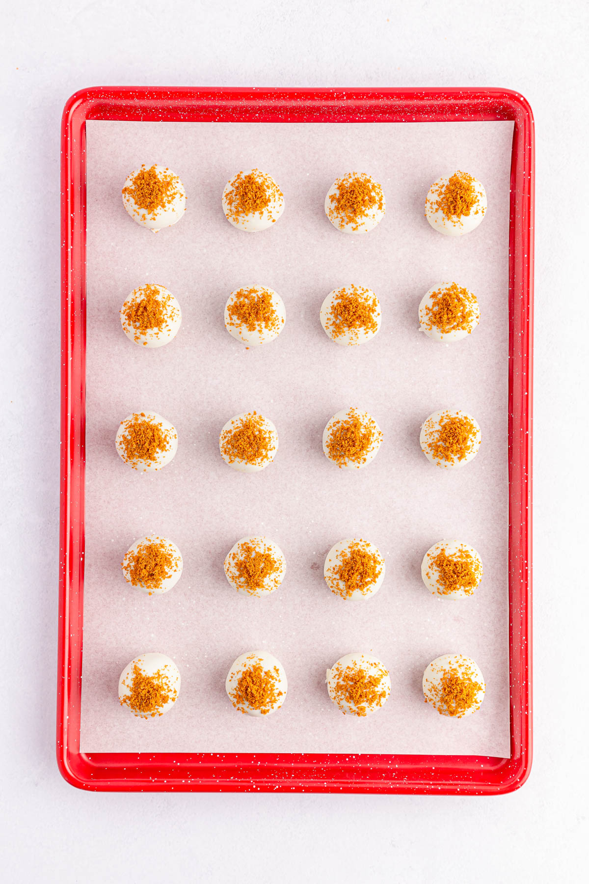 Biscoff Truffles topped with Biscoff crumbs on cookie sheet