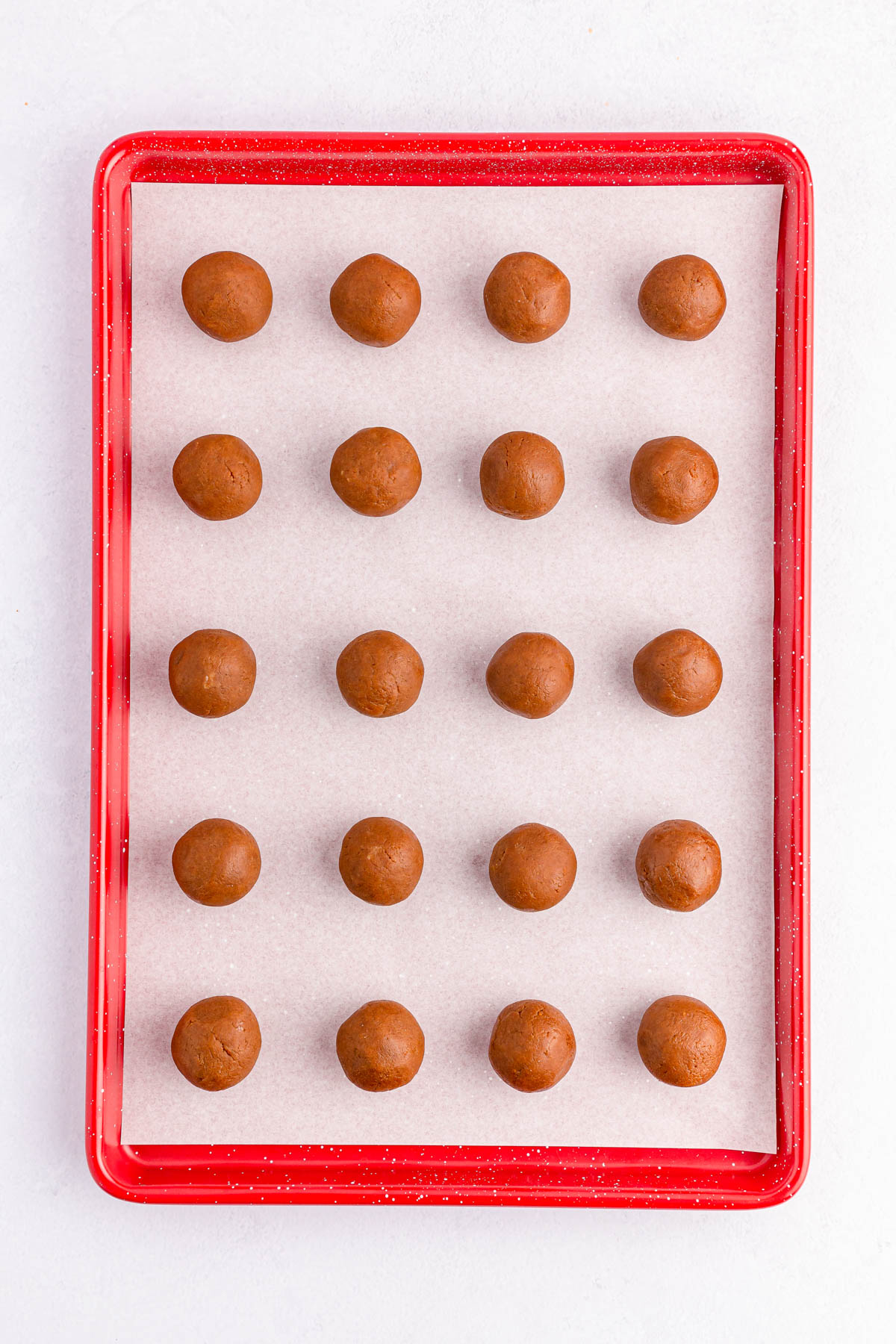 Biscoff balls on baking sheet covered in parchment paper