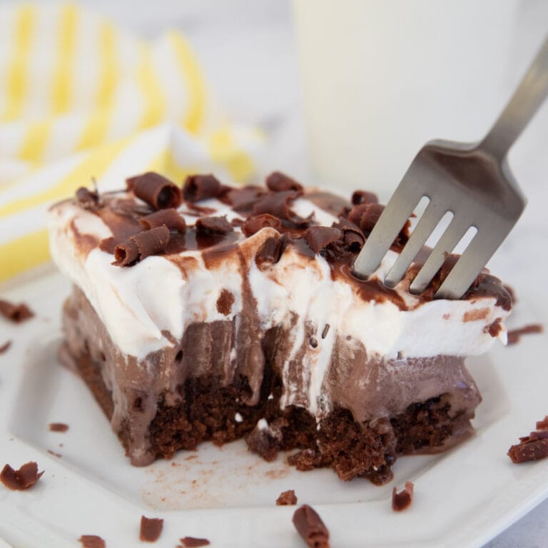 Brownie ice cream cake with a fork and a bite taken out of it