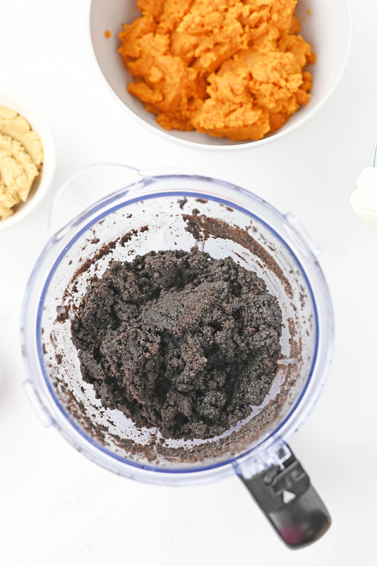 Oreo cookie crumbs and butter in food processor