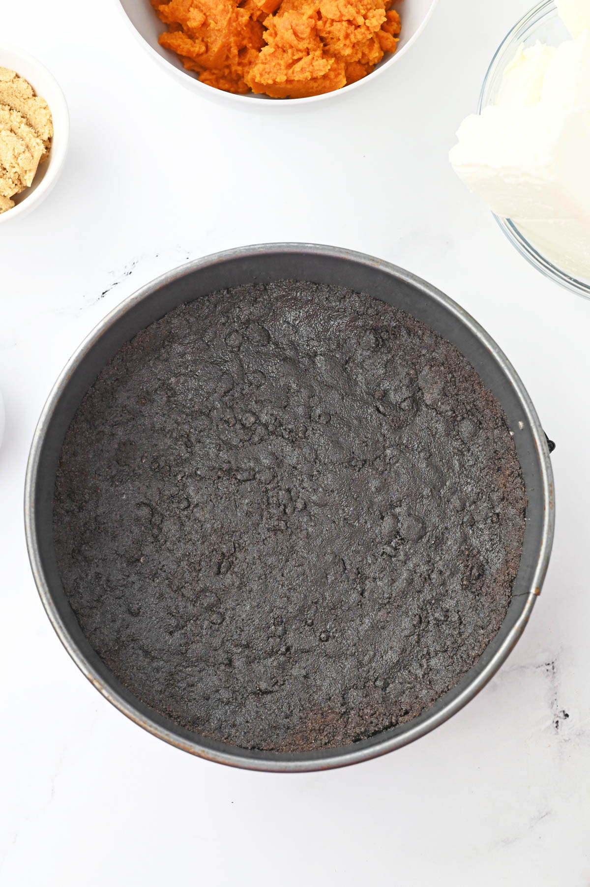 Oreo cookie crust in cheesecake pan