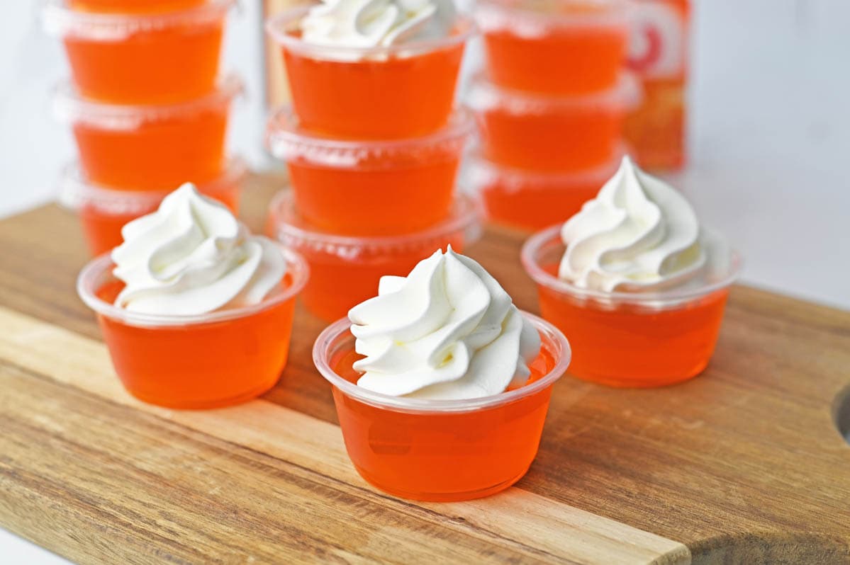 Orange jello shots with whipped cream