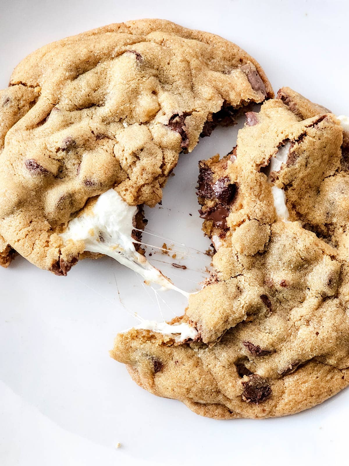 Smore's cookie cracked open with gooey marshmallow