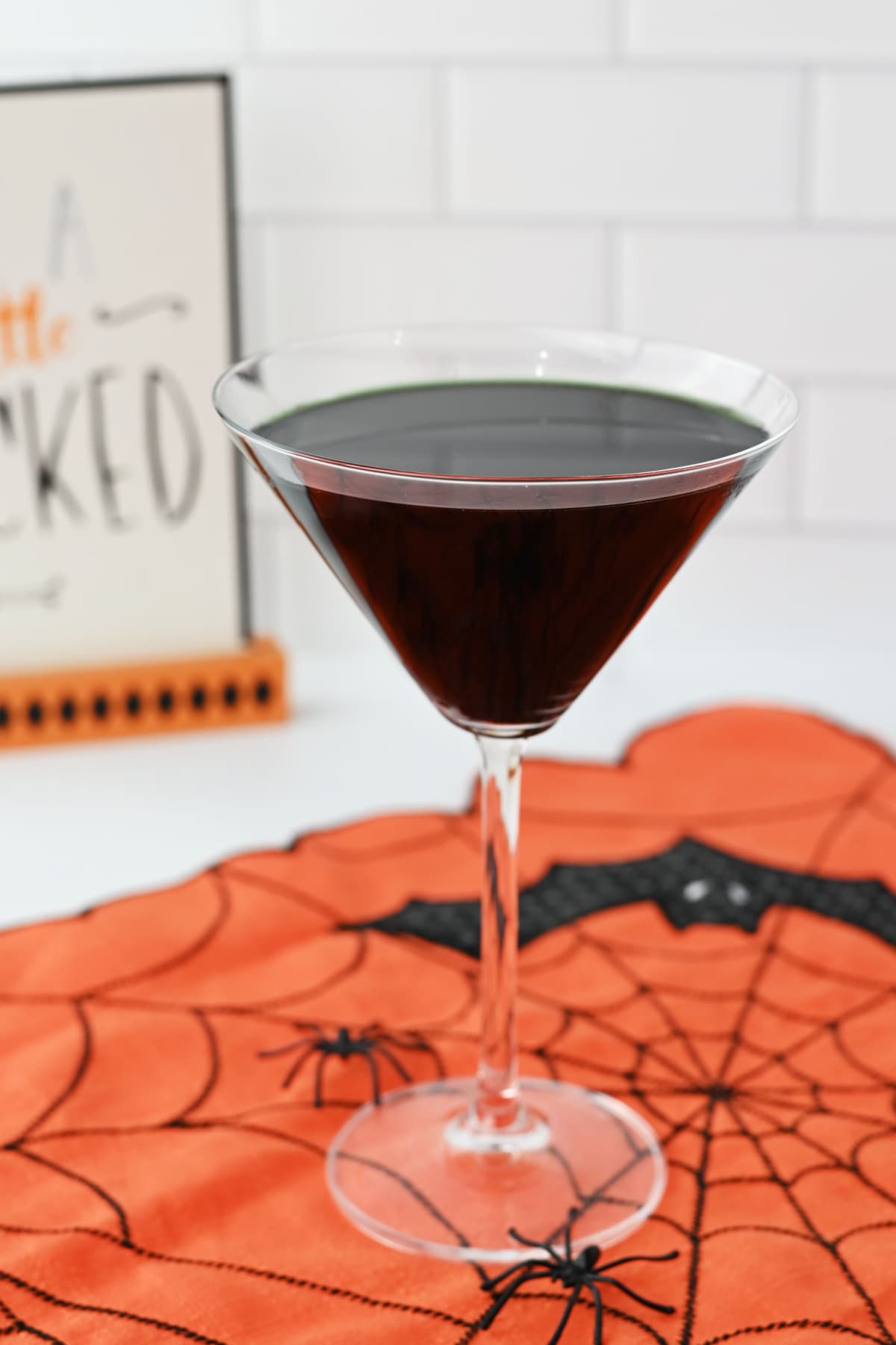 Black martini on orange Halloween decor