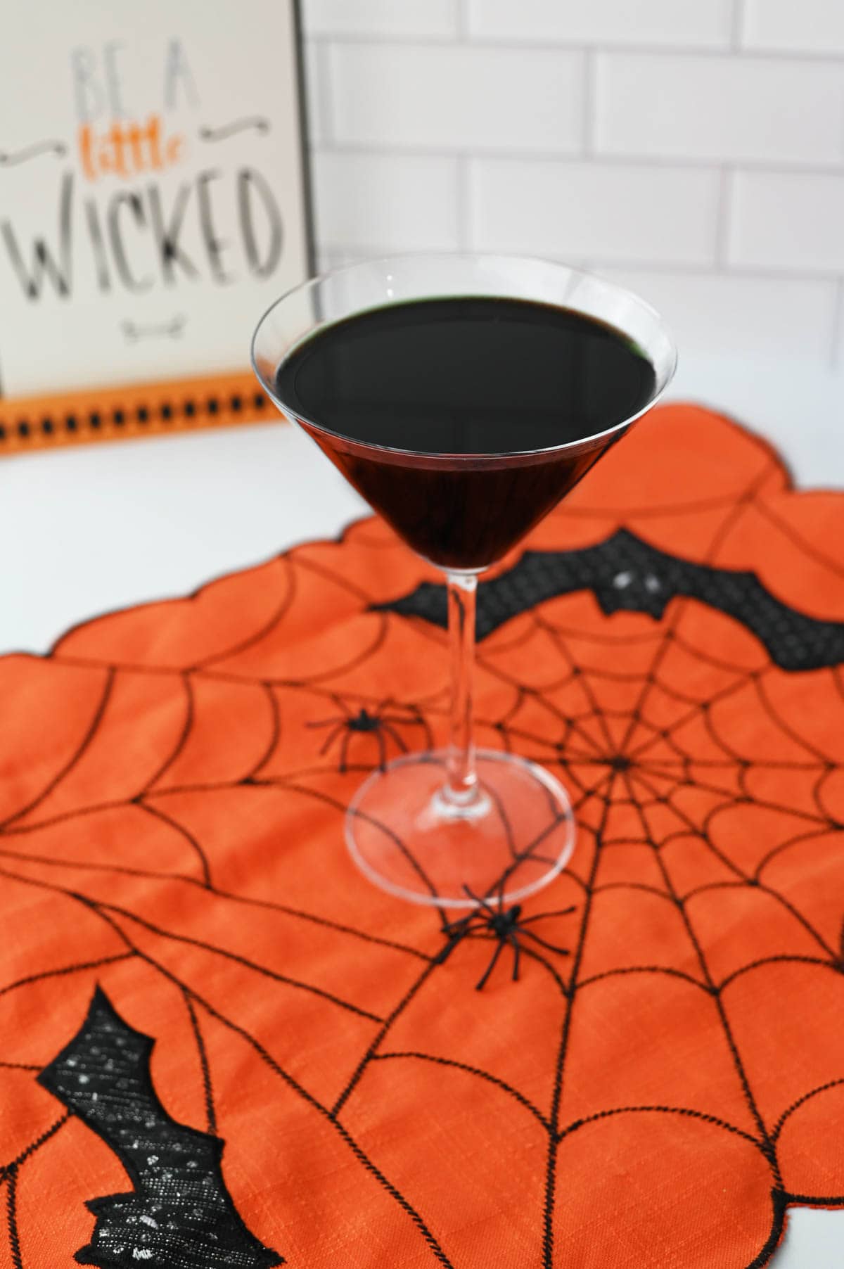 Black martini on orange spiderweb decor
